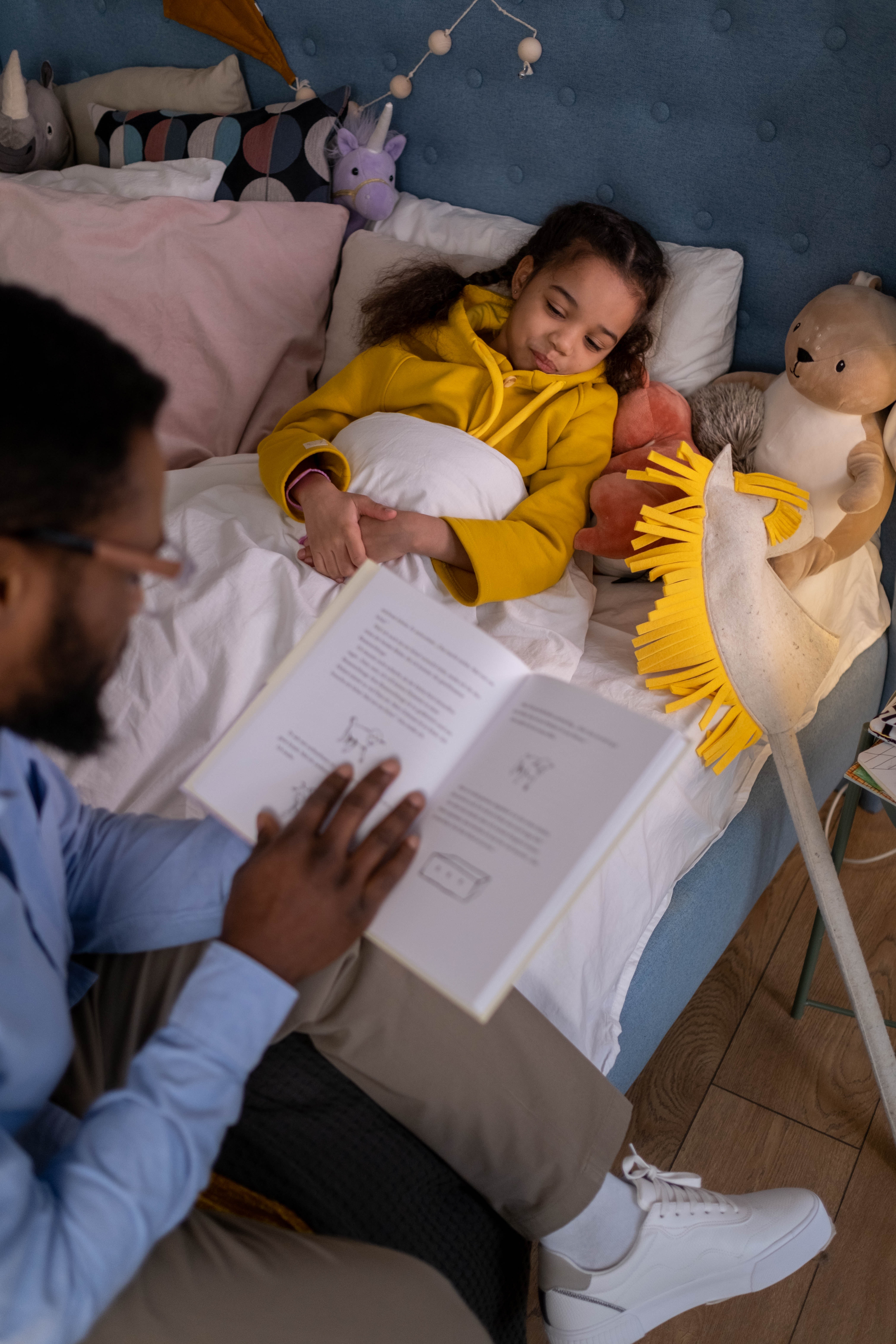 photo by cottonbro: https://www.pexels.com/photo/a-father-reading-bedtime-story-to-his-daughter-6591638/
